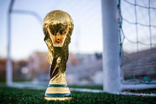 Goldener Pokal auf dem Fußballrasen