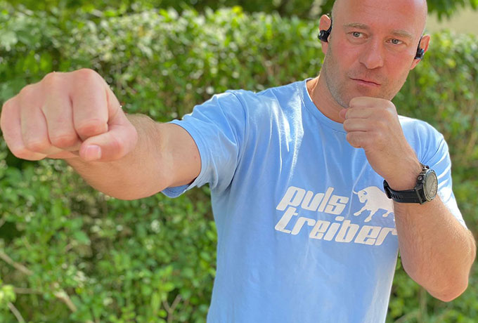 Mann in Boxerpose mit Sportkopfhörer „MiiBUDS ACTION II“ von MIIEGO